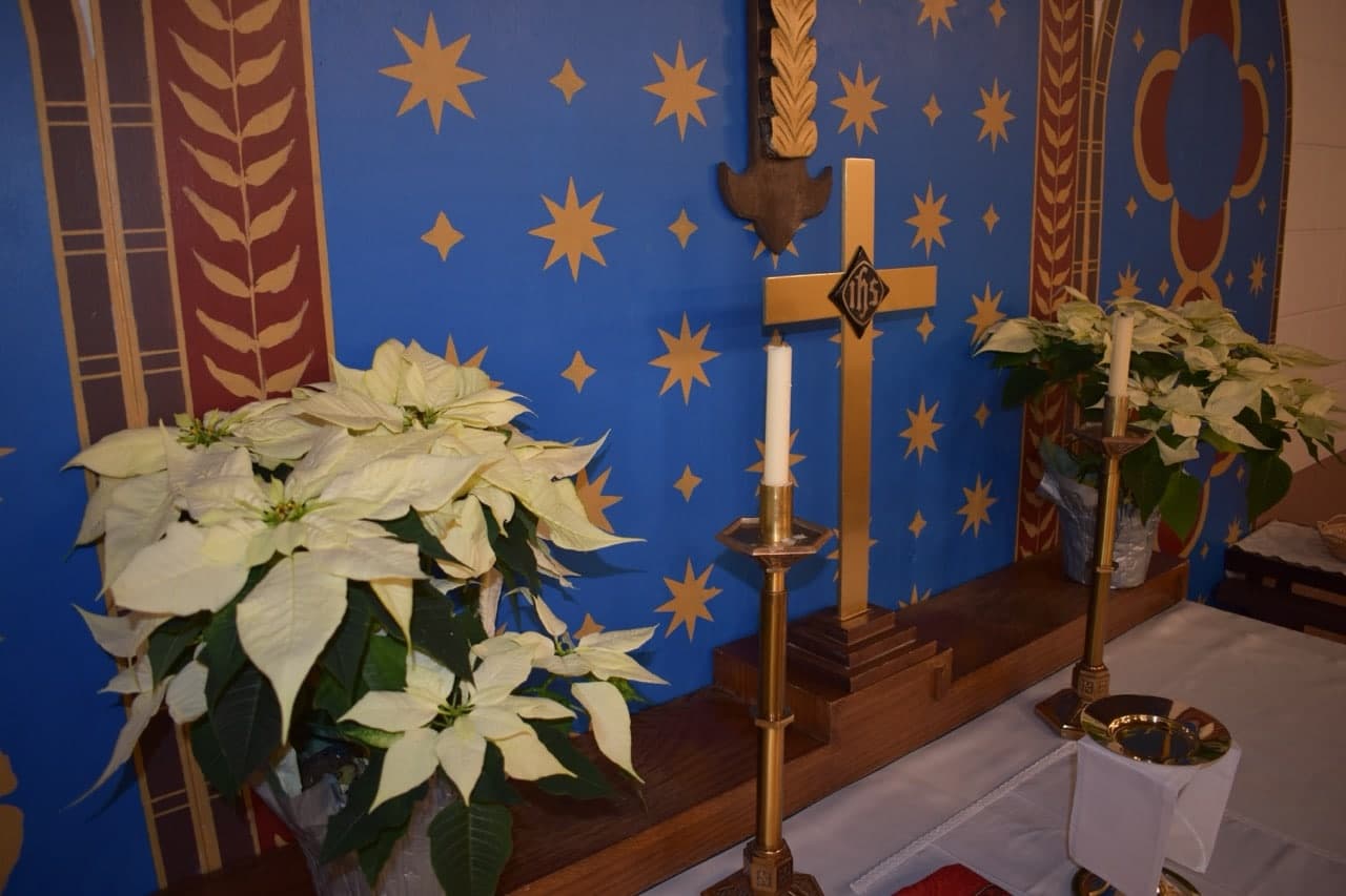 Candles and poinsettias at the altar of Christ Church