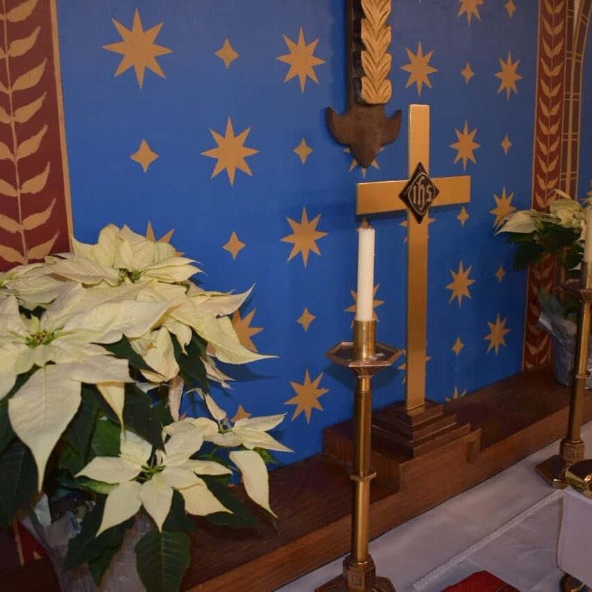 Candles and poinsettias at the altar of Christ Church